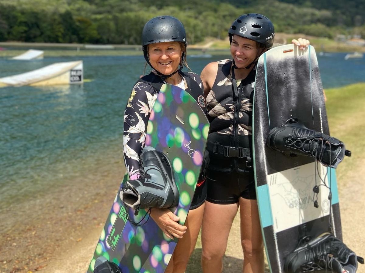 Masters women posing for a photo holding their wakeboards