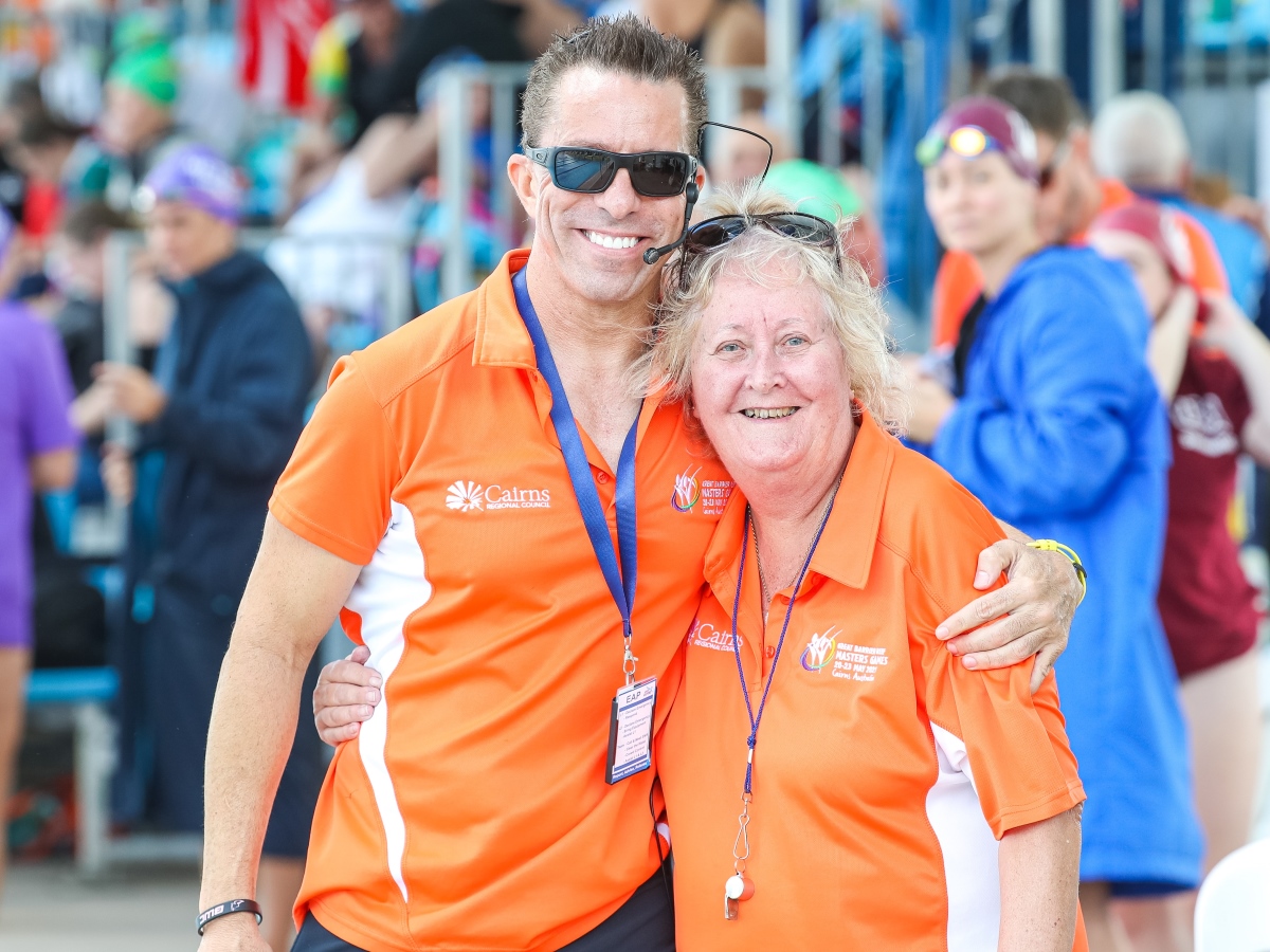 Woman and man at swimming carnival smiling and posing for the camera